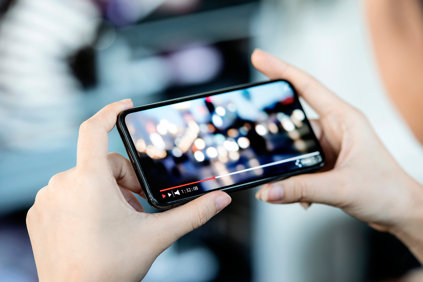 Female Hand Holding Smartphone and Watching Video